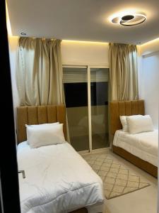 a bedroom with two beds and a window at Vue Mer Exeptionnelle à Essaouira in Essaouira +6 photos