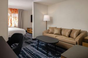 a hotel room with a couch and a bed at Fairfield Inn & Suites Grand Rapids in Grand Rapids +23 photos
