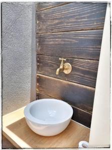 a white bowl sitting on top of a wooden table at Un ptit coin de bonheur in Cul de Sac +34 photos