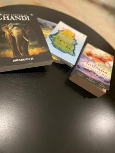 two books sitting on top of a table at Harbor Moon in Hiriketiya +18 photos