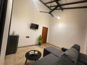 a living room with a couch and a table at Harbor Moon in Hiriketiya
