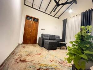 a living room with a couch and a table at Harbor Moon in Hiriketiya