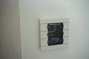 a microwave oven hanging on a white wall at Aupark Apartments in Vienna