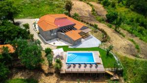 an overhead view of a house with a swimming pool at Quinta dos Castanheiros in Oliveira de Frades