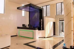 a lobby with a bar with blue lights on it at Dreamz Hotel and Suites in Ogbomoso