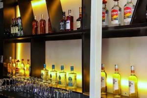 a shelf filled with lots of bottles of alcohol at Dreamz Hotel and Suites in Ogbomoso +2 photos