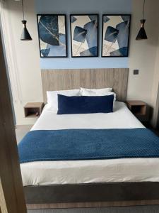 a bedroom with a bed with four pictures on the wall at UniqueMine Apartamento Deluxe in Bogotá +31 photos