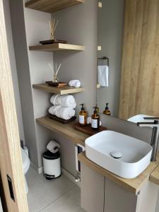 a bathroom with a white sink and a mirror at UniqueMine Apartamento Deluxe in Bogotá