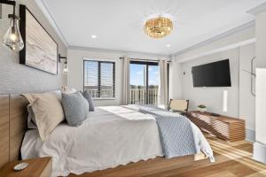 a bedroom with a large bed and a tv at Mama's Little House in Virginia Beach