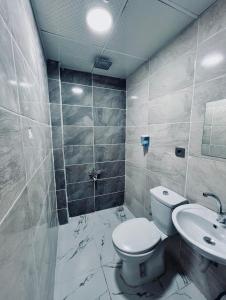 a bathroom with a toilet and a sink at Gazisehir gold hotel in Şahinbey