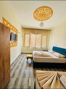 a bedroom with a bed and a chandelier at Gazisehir gold hotel in Şahinbey