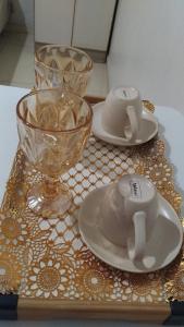 a table with two plates and a cup and a bowl at Quarto próximo aeroporto, mangueirão, rodoviária, UFPA in Belém