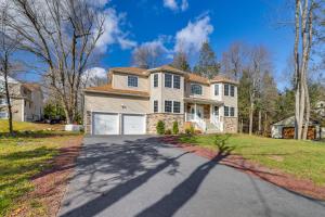 a house with a driveway with a garage at Hot Tub and Lake Access Spacious Tobyhanna Home in Tobyhanna