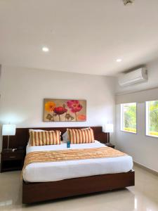 a bedroom with a large bed with two pillows at Hotel Neiva Plaza in Neiva