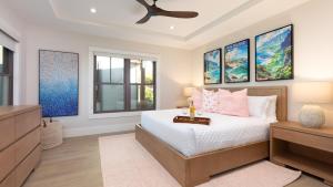 a bedroom with a bed and a dresser and windows at ❤PiH❤ Hale Moana Heated Private Pool Spa Detached Ohana Suite in Waimea +92 photos
