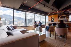 a room with a couch and a bar with a view at UniqueMine Apartamento Deluxe in Bogotá