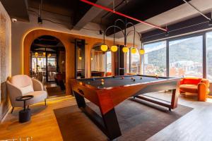 a living room with a pool table in a room at UniqueMine Apartamento Deluxe in Bogotá