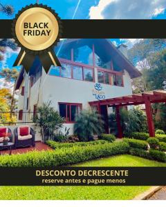 a house with a black friday sign in front of it at Pousada do Lago - Gramado in Gramado