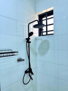 a black lamp on a wall in a room at DipNik Residence in Lagos +16 photos