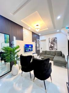 a living room with a couch and a table and chairs at DipNik Residence in Lagos