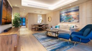 a living room with a couch and a table at ❤PiH❤ Hapuna Sunsets Beachfront Steps From Ocean A33 in Hapuna Beach