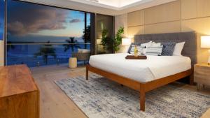 a bedroom with a bed and a large window at ❤PiH❤ Hapuna Sunsets Beachfront Steps From Ocean A33 in Hapuna Beach +50 photos