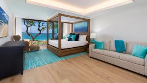 a living room with a bed and a couch at ❤PiH❤ Hapuna Beachfront Bliss Beachfront Steps From Ocean B29 in Hapuna Beach +46 photos