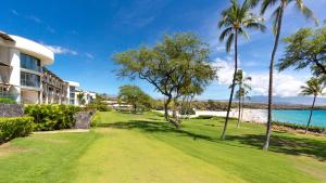 a view of a resort with palm trees and the ocean at ❤PiH❤ Hapuna Beachfront Bliss Beachfront Steps From Ocean B29 in Hapuna Beach