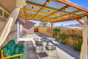 a patio with a table and chairs under a pergola at Family Home, 7 Mi to Joshua Tree National Park! in Twentynine Palms