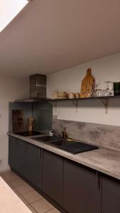 a kitchen with a sink and a counter top at L Antre du Désir in Saint-Léonard
