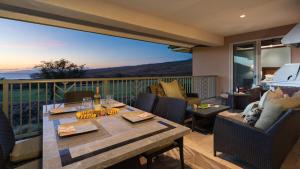 a dining room with a table and chairs on a balcony at ❤PiH❤ Endless Ocean Views Villa Gorgeous Mauna Kea Ocean and Mountain View in Hapuna Beach