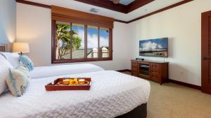 a bedroom with a bed with a tray of fruit on it at ❤PiH❤ Endless Ocean Views Villa Gorgeous Mauna Kea Ocean and Mountain View in Hapuna Beach +48 photos
