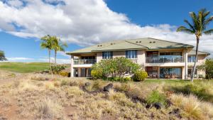 a house on a hill with palm trees at ❤PiH❤ Endless Ocean Views Villa Gorgeous Mauna Kea Ocean and Mountain View in Hapuna Beach