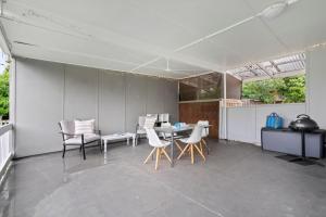 a dining room with a table and chairs in a room at Seascape On Cairnes in Indented Head