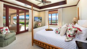 a bedroom with a bed and a chair and windows at ❤PiH❤ Ikena Nani Ocean Coastline Views Mauna Kea Resort in Waimea +58 photos