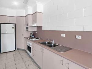 a kitchen with a sink and a white refrigerator at Arcadia Beach Unit 4 in Arcadia