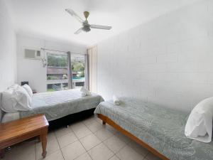 a bedroom with two beds and a ceiling fan at Arcadia Beach Unit 4 in Arcadia +8 photos
