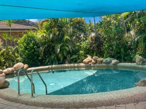 a large swimming pool with a blue umbrella at Arcadia Beach Unit 4 in Arcadia