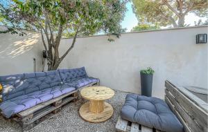 a purple couch and a table and a tree at Nice Home In Cabannes in Cabannes +5 photos