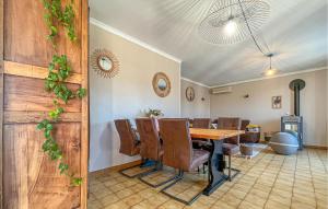 a dining room with a table and chairs at Nice Home In Cabannes in Cabannes
