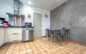 a kitchen with a table and chairs in a room at Nice Home In Cabannes in Cabannes