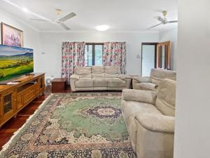 a living room with a couch and a flat screen tv at Arcadia Gardens in Arcadia