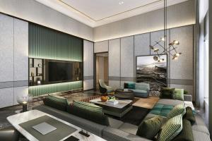 a living room with a couch and a tv at Sheraton Kota Kinabalu in Kota Kinabalu