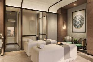 a spa room with four beds and a mirror at Sheraton Kota Kinabalu in Kota Kinabalu