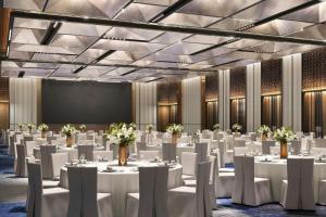 a conference room with white tables and chairs at Sheraton Kota Kinabalu in Kota Kinabalu