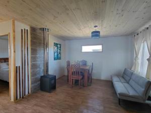 a living room with a couch and a table at Cabaña Aeropuerto el Tepual 3 in Puerto Montt