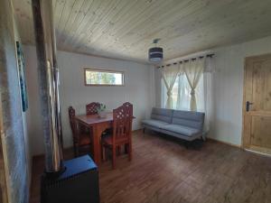 a living room with a couch and a table at Cabaña Aeropuerto el Tepual 3 in Puerto Montt