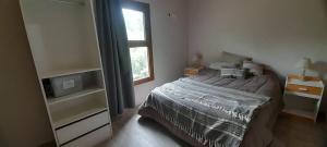 シエラ・デ・ラ・ベンターナにあるVillage De Las Sierrasのベッドと窓のある寝室