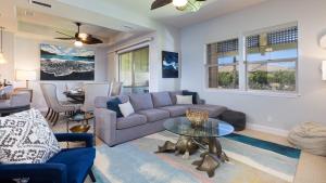 a living room with a couch and a table at ISLAND HIDEAWAY Modern 2BR Kulalani Home with Amazing Community Pools in Waikoloa