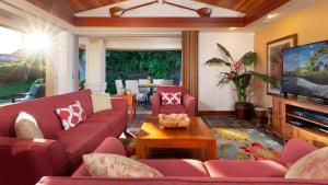 a living room with red couches and a flat screen tv at ❤PiH❤ Hale Kanani Hilton Resort PassesFully Detached HomeBeach Gear Bikes in Waikoloa